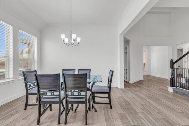 505 Ozark Ct, League City, TX 77573 - dining space featuring a chandelier, light wood-style flooring, stairs, vaulted ceiling, and ornamental molding