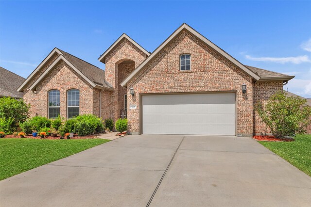 505 Ozark Ct, League City, TX 77573 - view of front of house featuring brick siding, concrete driveway, and an attached garage