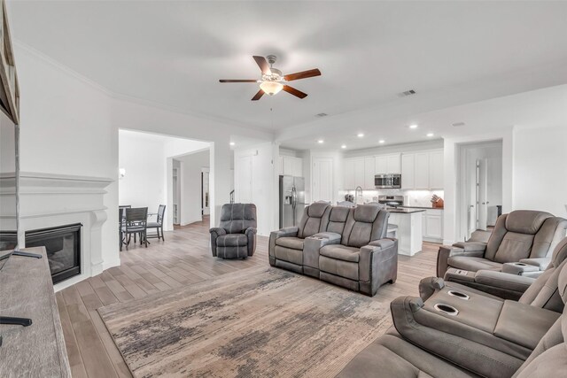 505 Ozark Ct, League City, TX 77573 - living room with ceiling fan, light wood-style floors, recessed lighting, and crown molding