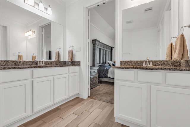 505 Ozark Ct, League City, TX 77573 - ensuite bathroom featuring wood finish floors, ornamental molding, and vanity
