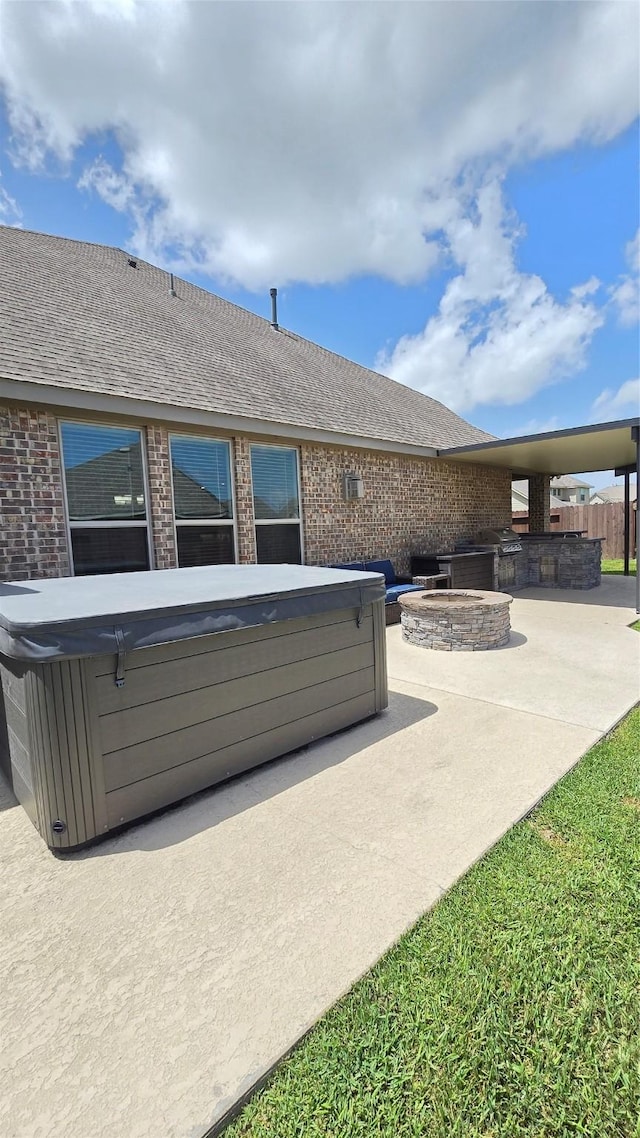 505 Ozark Ct, League City, TX 77573 - view of patio / terrace featuring a hot tub and a fire pit