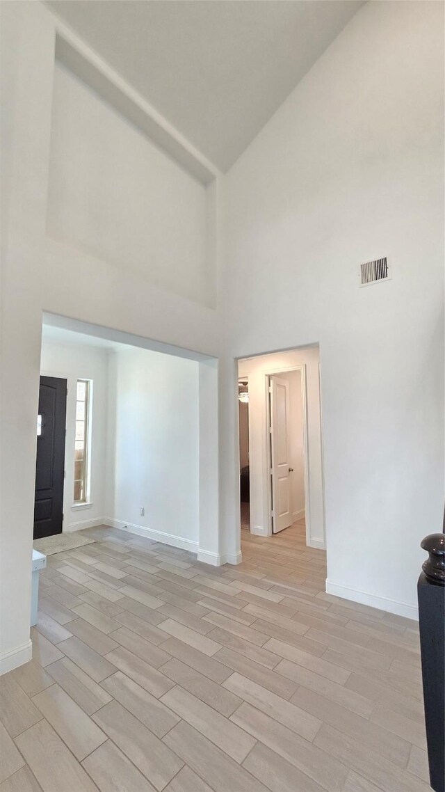505 Ozark Ct, League City, TX 77573 - spare room with high vaulted ceiling and light wood-type flooring
