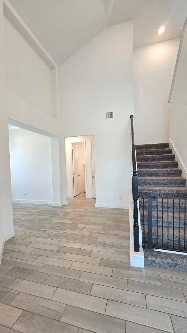 505 Ozark Ct, League City, TX 77573 - stairway featuring high vaulted ceiling and wood finished floors