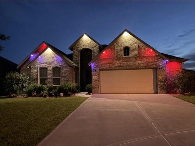 505 Ozark Ct, League City, TX 77573 - view of front of home with driveway, brick siding, an attached garage, and a lawn