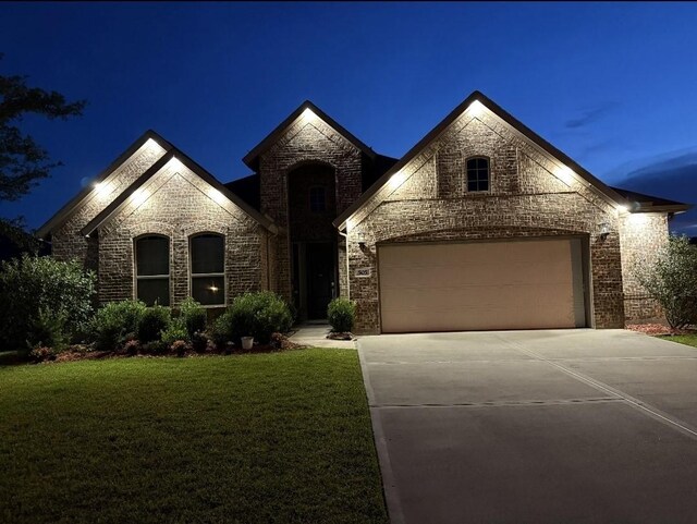 505 Ozark Ct, League City, TX 77573 - french country inspired facade featuring driveway, an attached garage, brick siding, a front yard, and stone siding