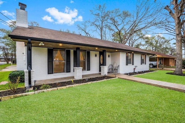 208 Moss Hill Ln, Conroe, TX 77303 - ranch-style home with a chimney, covered porch, brick siding, and a front lawn