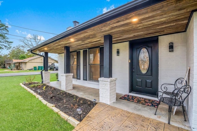 208 Moss Hill Ln, Conroe, TX 77303 - doorway to property featuring a porch and a yard