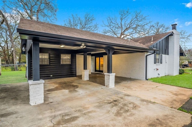 208 Moss Hill Ln, Conroe, TX 77303 - view of front of house featuring an attached carport, a chimney, brick siding, driveway, and a front yard