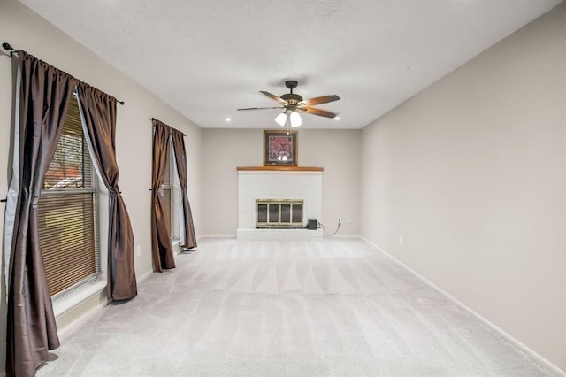 208 Moss Hill Ln, Conroe, TX 77303 - unfurnished living room featuring light carpet, a brick fireplace, and ceiling fan