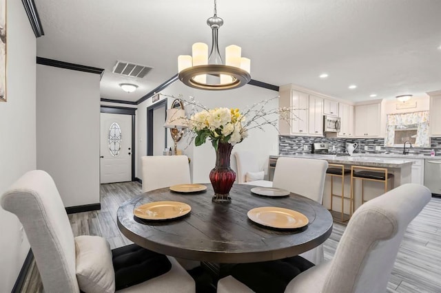 208 Moss Hill Ln, Conroe, TX 77303 - dining room with light wood-style floors, ornamental molding, and recessed lighting