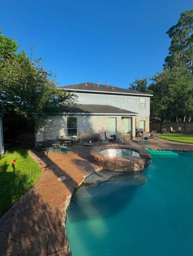 16519 Great Frst, Humble, TX 77346 - back of property with a pool with connected hot tub, brick siding, and a patio area