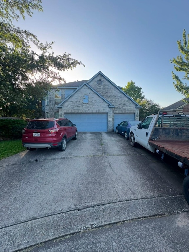 16519 Great Frst, Humble, TX 77346 - view of side of home with a garage, concrete driveway, and stone siding