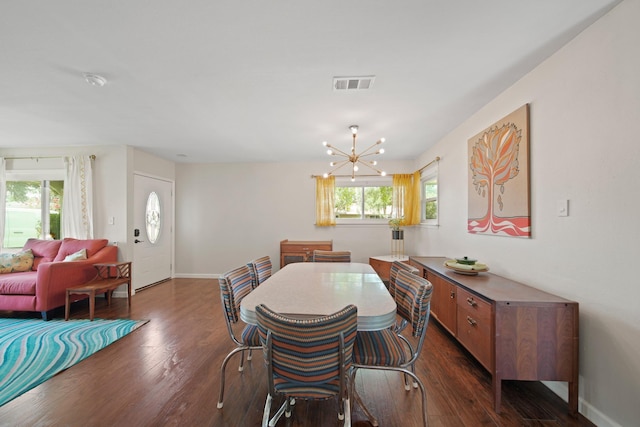 5411 Meadow Creek Ln, Houston, TX 77017 - dining space with dark wood finished floors, a chandelier, and plenty of natural light