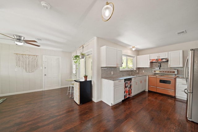 5411 Meadow Creek Ln, Houston, TX 77017 - kitchen with range with electric stovetop, freestanding refrigerator, under cabinet range hood, dark wood-style floors, and tasteful backsplash