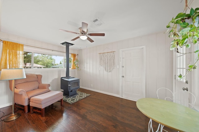 5411 Meadow Creek Ln, Houston, TX 77017 - sitting room with a wood stove, wood finished floors, and a ceiling fan