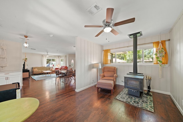 5411 Meadow Creek Ln, Houston, TX 77017 - sitting room featuring a wood stove, ceiling fan, and wood finished floors