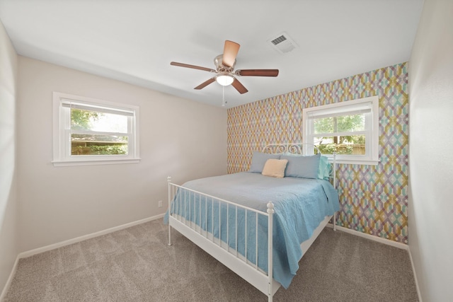 5411 Meadow Creek Ln, Houston, TX 77017 - bedroom with wallpapered walls, multiple windows, carpet floors, and a ceiling fan