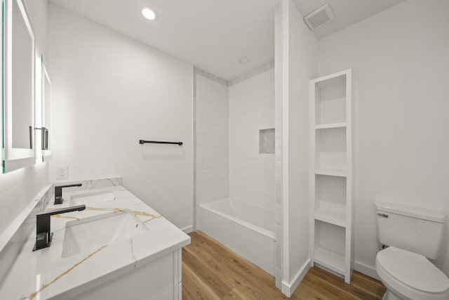 6206 Lyndhurst Dr, Houston, TX 77087 - bathroom featuring double vanity, wood finished floors, and washtub / shower combination
