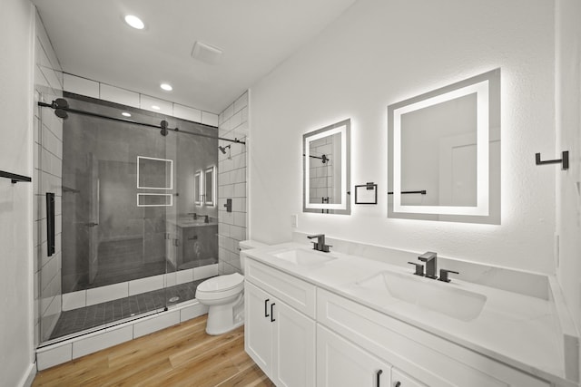 6206 Lyndhurst Dr, Houston, TX 77087 - bathroom featuring double vanity, a stall shower, wood finished floors, and recessed lighting