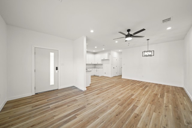 6206 Lyndhurst Dr, Houston, TX 77087 - unfurnished living room featuring a ceiling fan, recessed lighting, light wood finished floors, and a chandelier