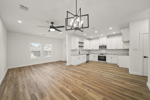 6206 Lyndhurst Dr, Houston, TX 77087 - kitchen with stainless steel appliances, open floor plan, light countertops, backsplash, and recessed lighting