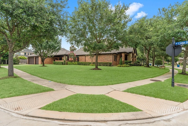 12218 Johns Enterprise Ct, Cypress, TX 77433 - view of front of house with brick siding, an attached garage, and a front yard