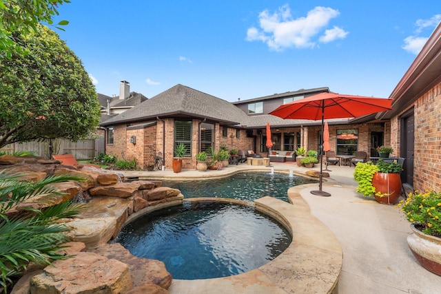 12218 Johns Enterprise Ct, Cypress, TX 77433 - view of swimming pool featuring a pool with connected hot tub, a patio, and an outdoor hangout area