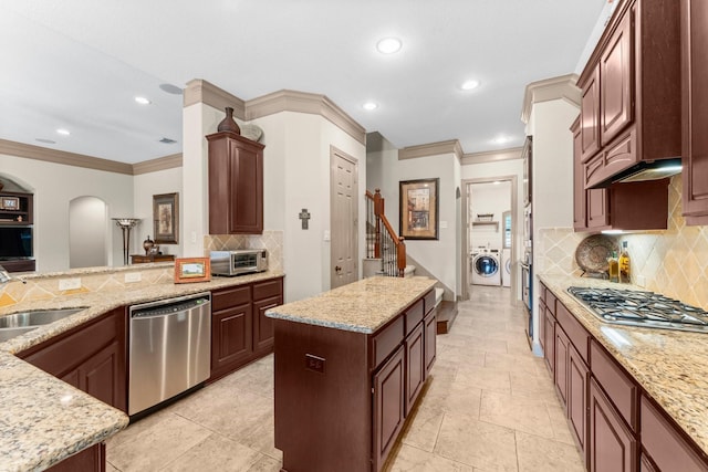 12218 Johns Enterprise Ct, Cypress, TX 77433 - kitchen featuring stainless steel appliances, crown molding, a center island, recessed lighting, and decorative backsplash
