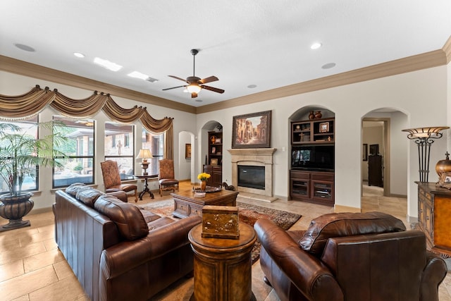 12218 Johns Enterprise Ct, Cypress, TX 77433 - living area featuring arched walkways, ornamental molding, built in features, ceiling fan, and a high end fireplace