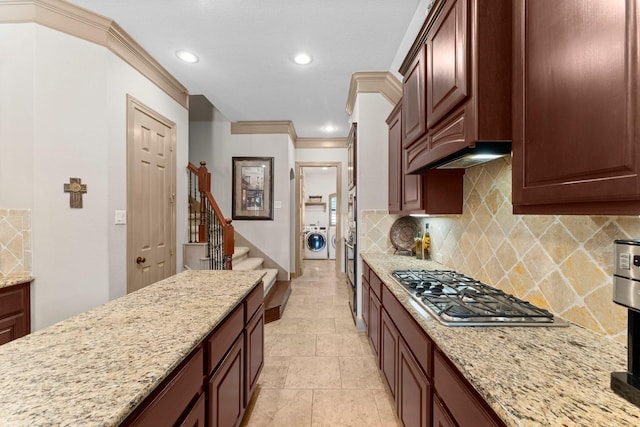 12218 Johns Enterprise Ct, Cypress, TX 77433 - kitchen with stainless steel gas cooktop, washing machine and dryer, recessed lighting, tasteful backsplash, and light stone counters