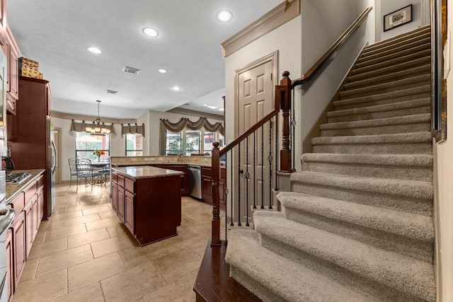 12218 Johns Enterprise Ct, Cypress, TX 77433 - kitchen featuring appliances with stainless steel finishes, recessed lighting, a chandelier, pendant lighting, and a kitchen island