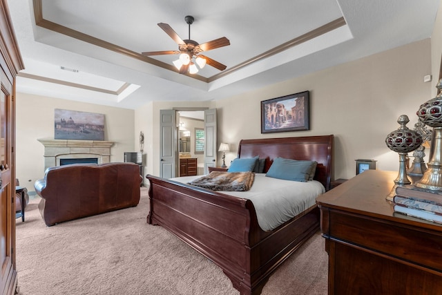 12218 Johns Enterprise Ct, Cypress, TX 77433 - carpeted bedroom with a raised ceiling, a fireplace, ensuite bathroom, ornamental molding, and a ceiling fan