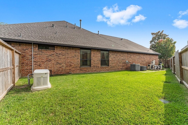 12218 Johns Enterprise Ct, Cypress, TX 77433 - back of house with a shingled roof, a fenced backyard, and brick siding