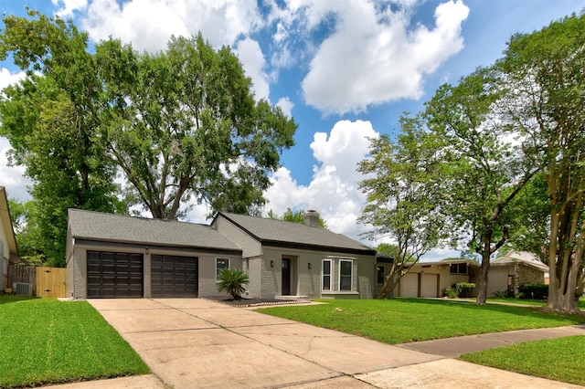 8822 Rowan Ln, Houston, TX 77036 - ranch-style house featuring a garage, concrete driveway, a front lawn, brick siding, and a chimney