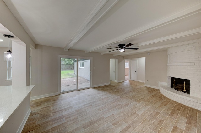 8822 Rowan Ln, Houston, TX 77036 - unfurnished living room with beam ceiling, a fireplace, light wood-style flooring, and a ceiling fan