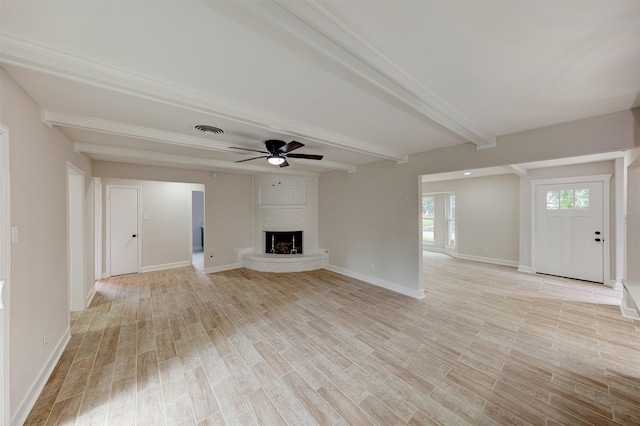 8822 Rowan Ln, Houston, TX 77036 - unfurnished living room featuring beam ceiling, a ceiling fan, light wood-style floors, and a fireplace