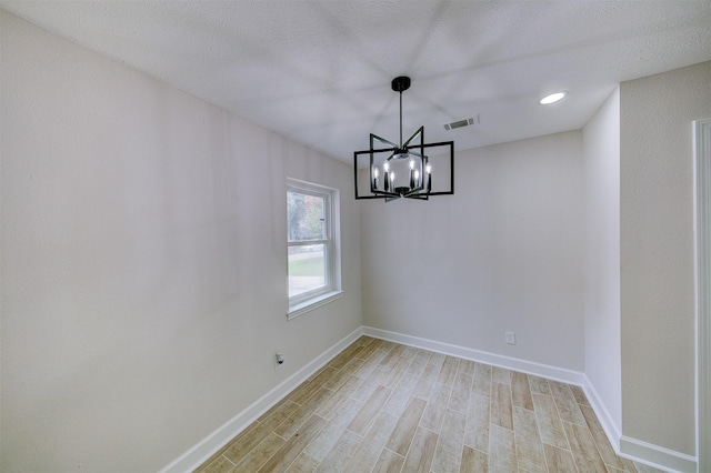 8822 Rowan Ln, Houston, TX 77036 - unfurnished dining area featuring light wood-style floors and a chandelier