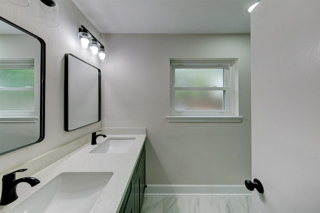 8822 Rowan Ln, Houston, TX 77036 - bathroom with double vanity and baseboards