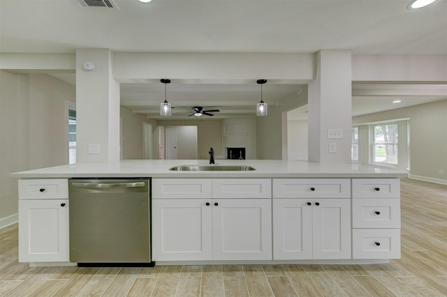 8822 Rowan Ln, Houston, TX 77036 - kitchen with stainless steel dishwasher, ceiling fan, white cabinets, light wood-style flooring, and beamed ceiling