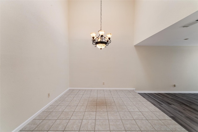 11614 Village Place Dr Unit 337, Houston, TX 77077 - unfurnished room with a chandelier, a high ceiling, and light tile patterned flooring