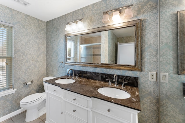 11614 Village Place Dr Unit 337, Houston, TX 77077 - full bathroom featuring healthy amount of natural light, double vanity, tile patterned flooring, and an enclosed shower