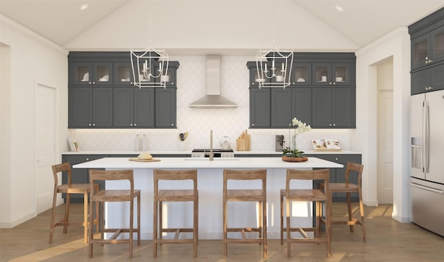 902 Hooks Trl, League City, TX 77573 - kitchen with wall chimney range hood, white fridge with ice dispenser, a chandelier, light countertops, and high vaulted ceiling