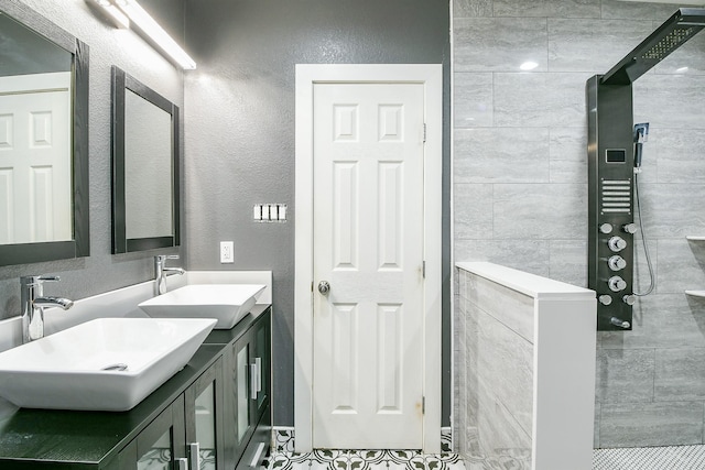 910 11th St, South Houston, TX 77587 - bathroom with double vanity, a walk in shower, and a textured wall