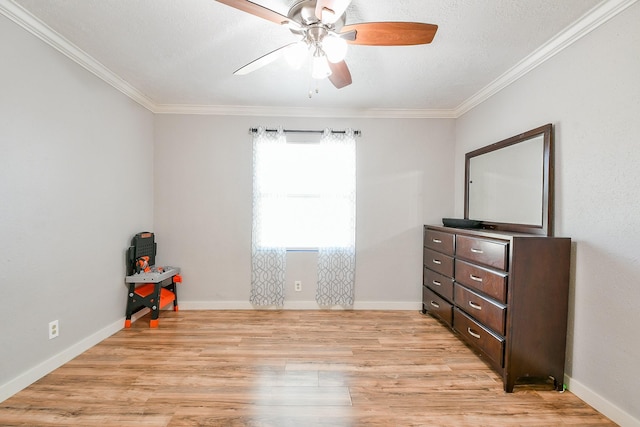 910 11th St, South Houston, TX 77587 - unfurnished bedroom with ornamental molding, light wood-style flooring, a ceiling fan, and a textured ceiling