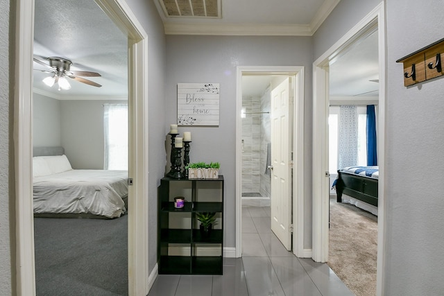 910 11th St, South Houston, TX 77587 - corridor featuring tile patterned floors, crown molding, and carpet flooring