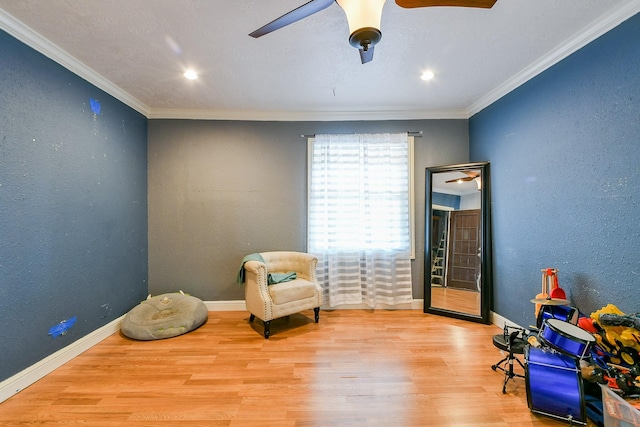 910 11th St, South Houston, TX 77587 - living area with wood finished floors, crown molding, a ceiling fan, a textured wall, and recessed lighting