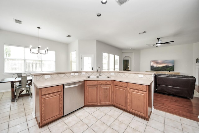 3214 Oak Park Ln, Missouri City, TX 77459 - kitchen featuring dishwasher, light countertops, open floor plan, a ceiling fan, and a chandelier