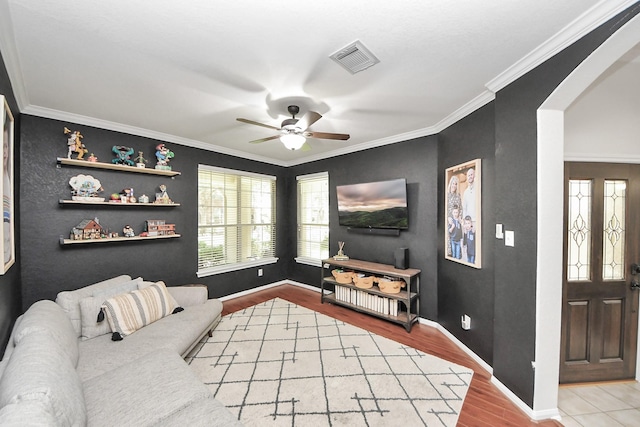 3214 Oak Park Ln, Missouri City, TX 77459 - living area featuring ceiling fan, wood finished floors, ornamental molding, and arched walkways