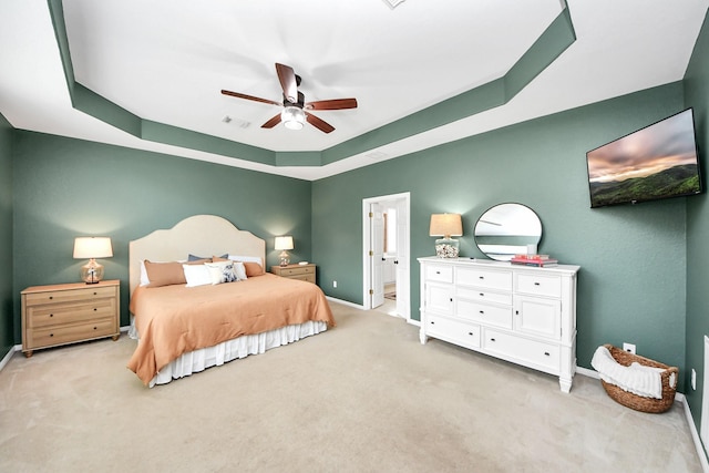 3214 Oak Park Ln, Missouri City, TX 77459 - bedroom featuring light carpet, a raised ceiling, a ceiling fan, and ensuite bathroom