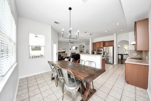 3214 Oak Park Ln, Missouri City, TX 77459 - dining area featuring light tile patterned floors, a chandelier, arched walkways, recessed lighting, and ceiling fan
